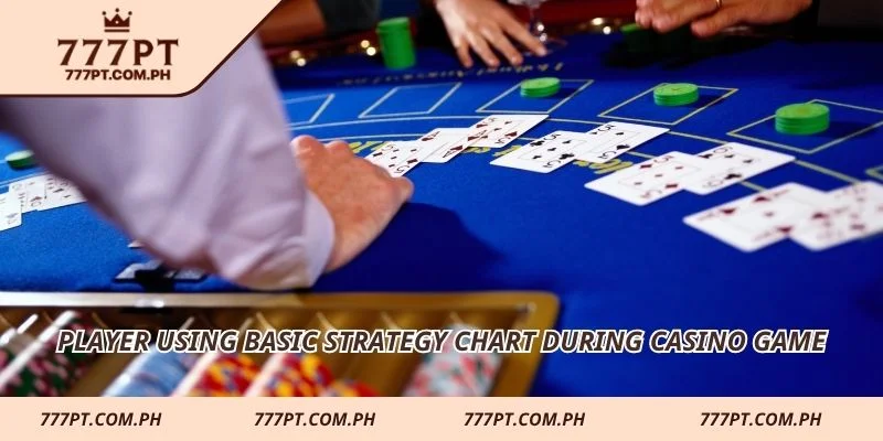 Player using basic strategy chart during casino game